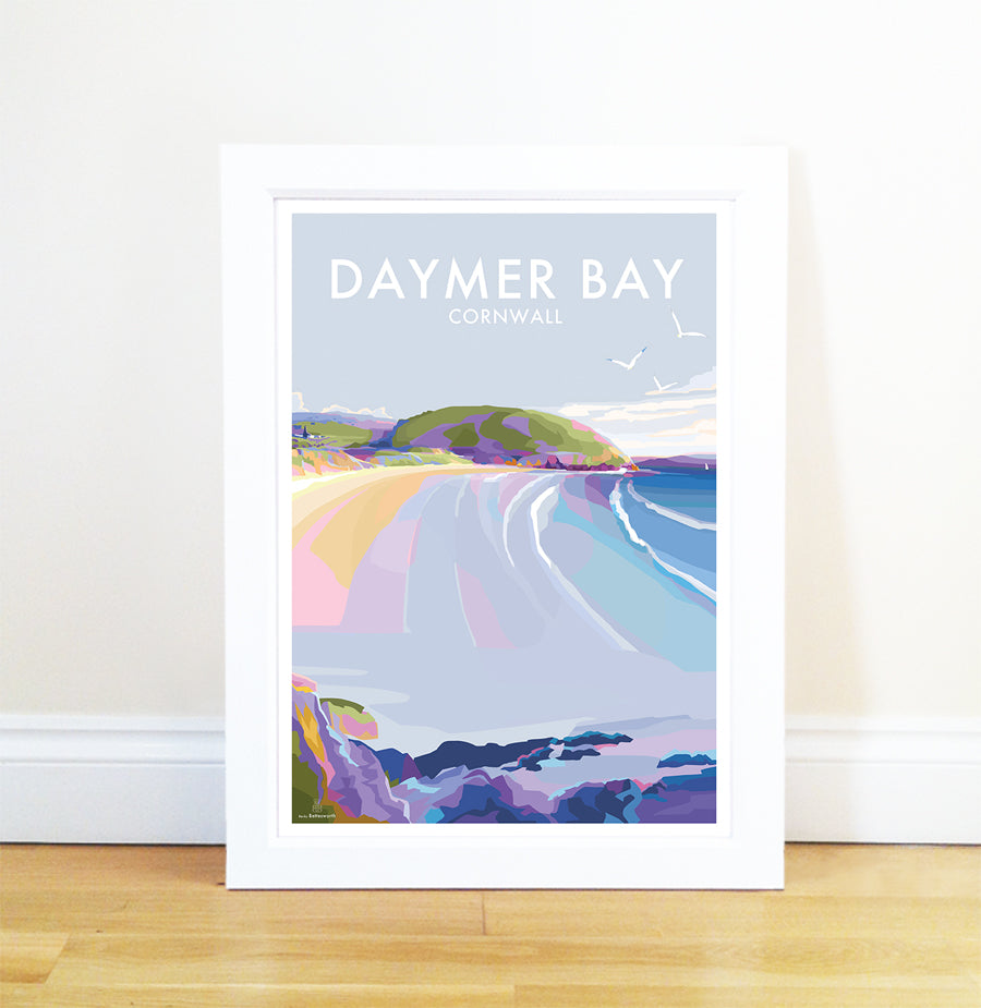 Framed print Daymer Bay by Becky Bettesworth features a vibrant, stylized seaside scene with waves, sandy beach, cliffs, and seagulls. Resting against a white wall on a wooden floor, it captures the essence of the Camel Estuary.